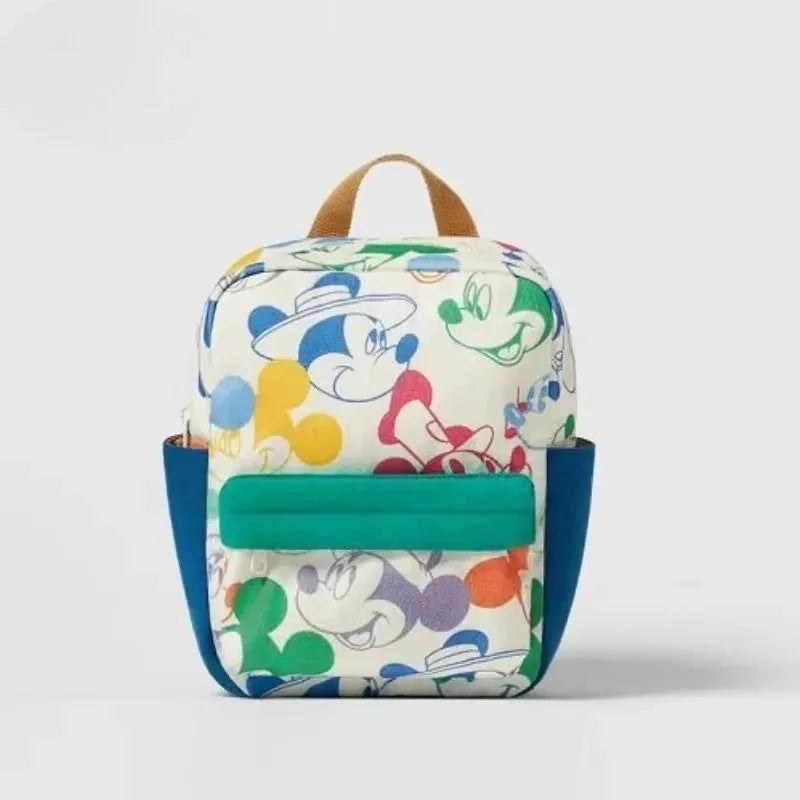 A light-colored backpack featuring a cartoon mouse print and a teal accent panel.