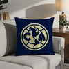A navy blue decorative pillow featuring a gold-colored circular logo with the letters CA and a map of North America.