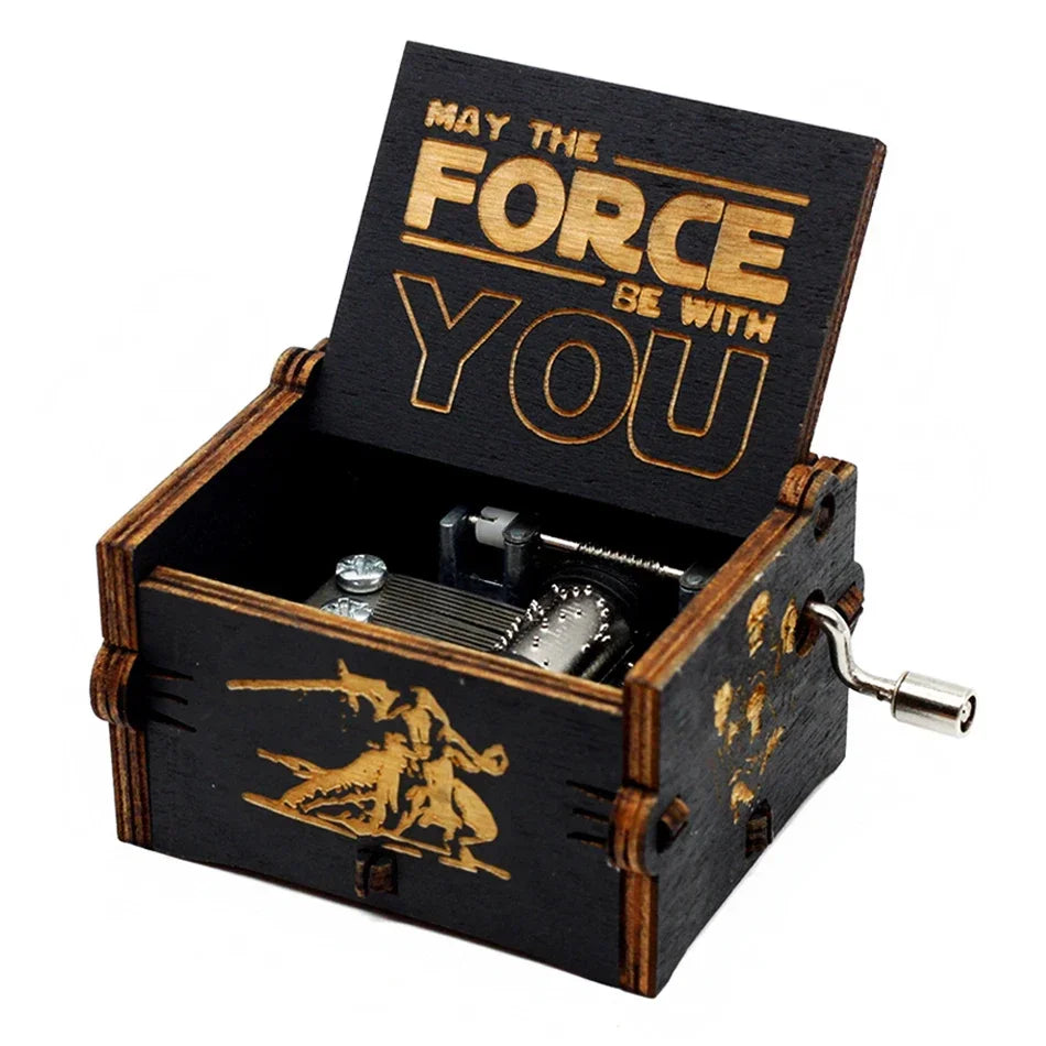 A dark wooden music box with an engraved lid featuring the text May The Force Be With You