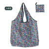 A floral patterned reusable nylon shopping tote bag with a drawstring closure and matching pouch.