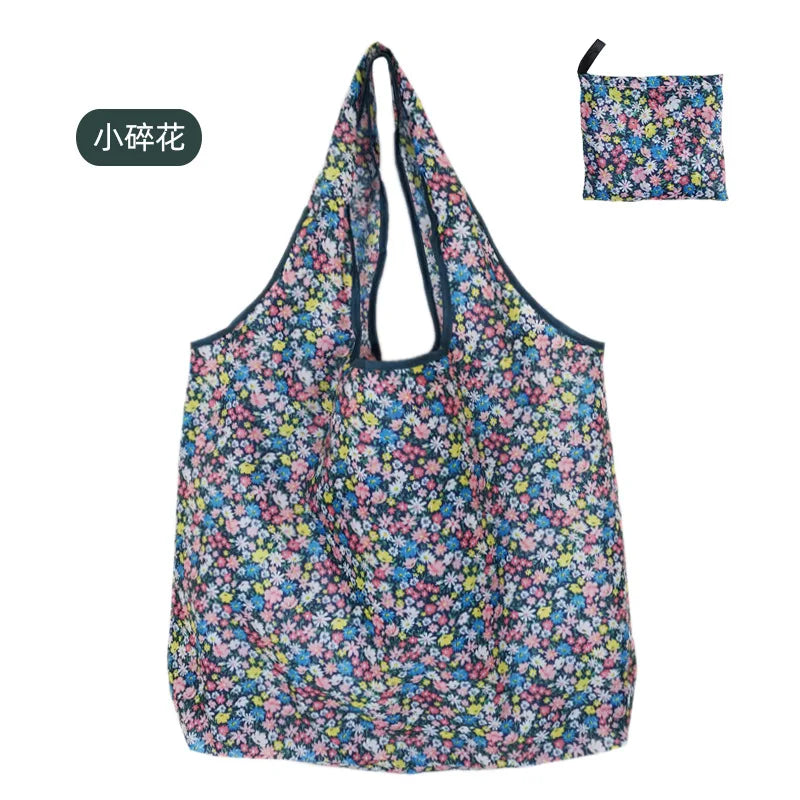A floral patterned reusable nylon shopping tote bag with a drawstring closure and matching pouch.