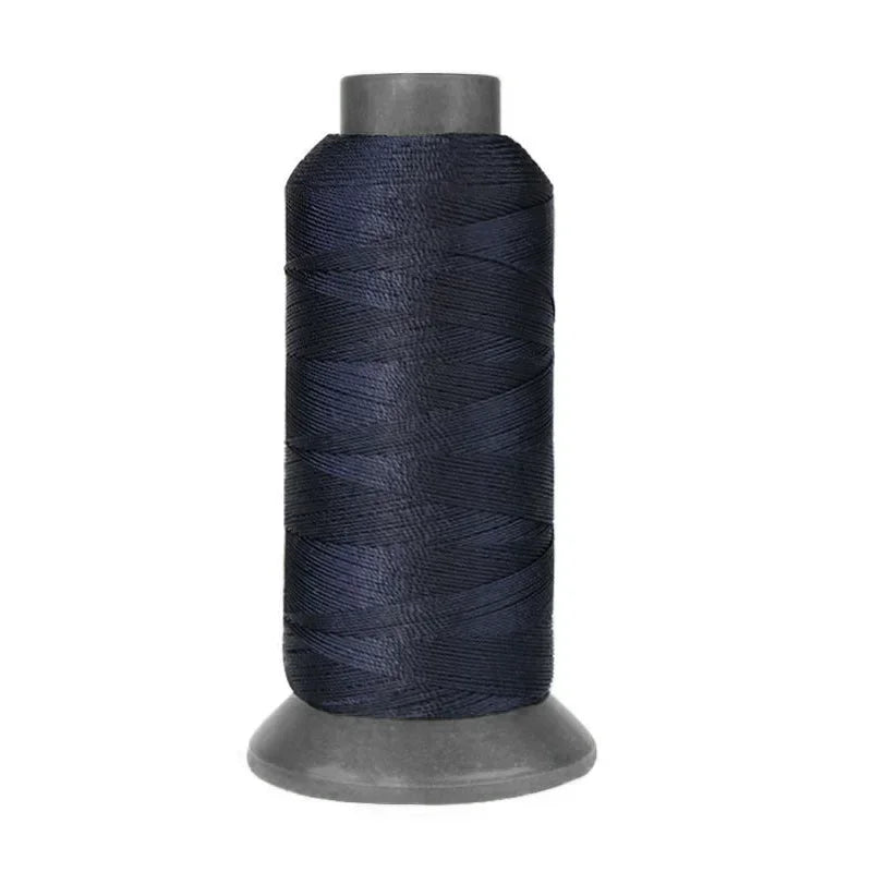 A spool of dark navy blue heavy-duty nylon sewing thread for upholstery and denim.
