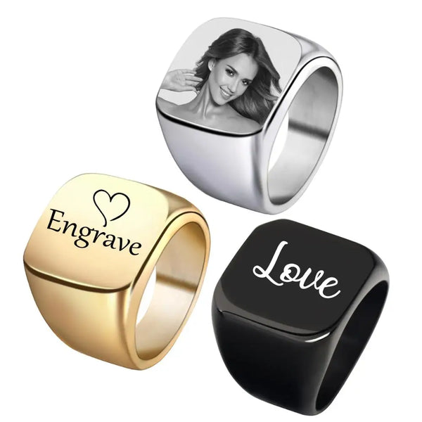 A set of personalized square stainless steel rings, including a silver ring and a gold ring, featuring an engraved design.