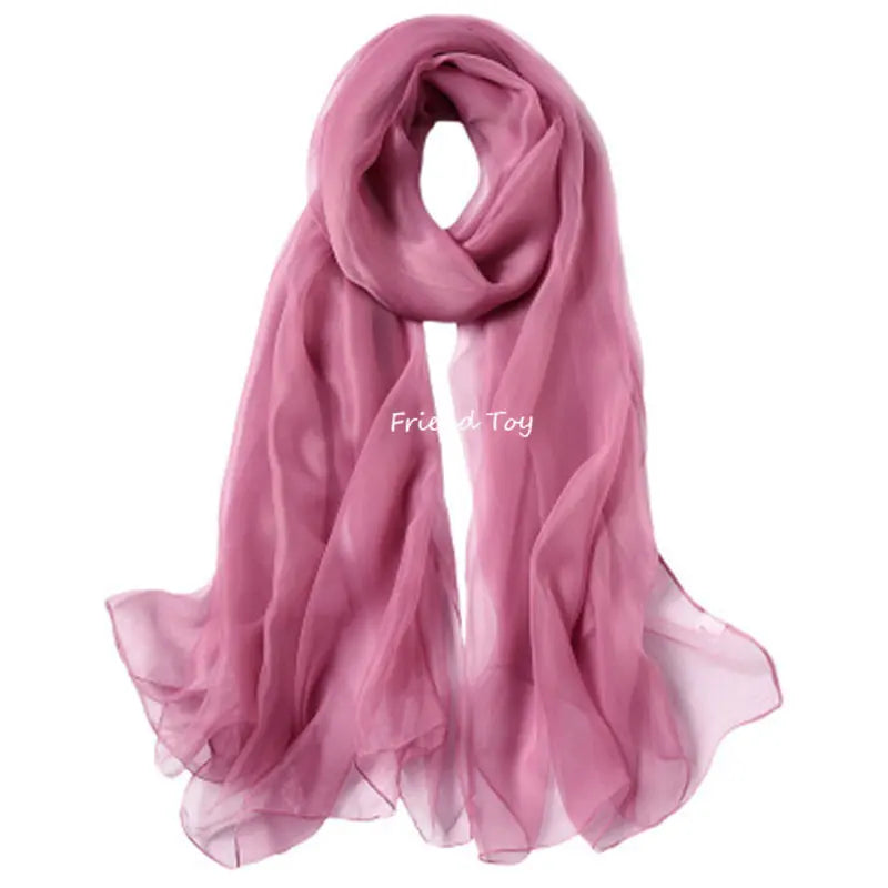 A sheer, dusty rose pink silk scarf draped elegantly.