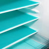 A close-up view of a white refrigerator liner mat with teal mesh inserts inside a storage shelf.