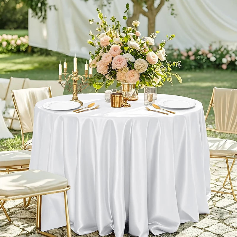 Elegant round satin tablecloth set for weddings and parties with floral centerpiece