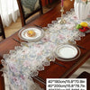A long table runner with floral lace detail is displayed on a wooden table.