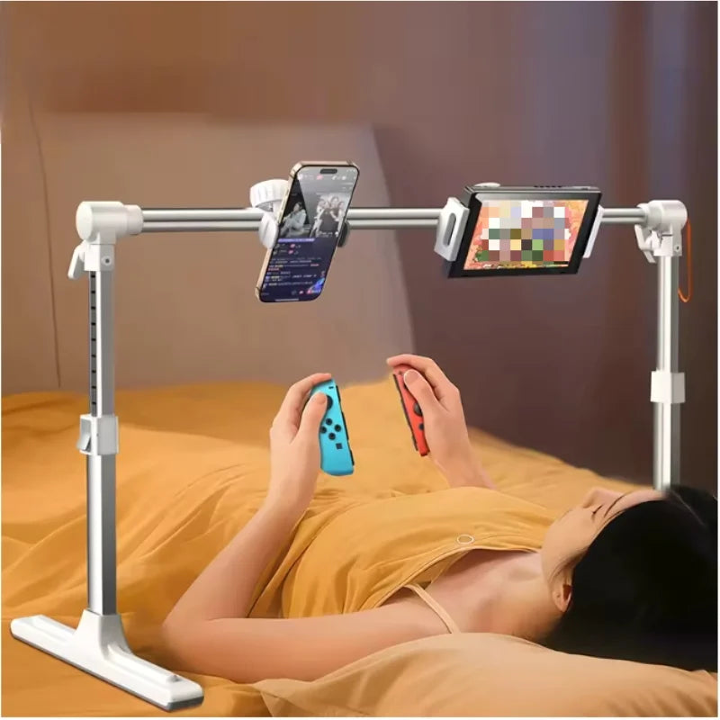 A woman is using an adjustable foldable tablet stand to hold a smartphone and a tablet while lying down.
