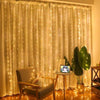 A sheer cream curtain decorated with warm white LED string lights, illuminating a room setting.