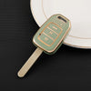 A light green protective TPU key fob cover for a Honda vehicle is shown resting on a white plate.