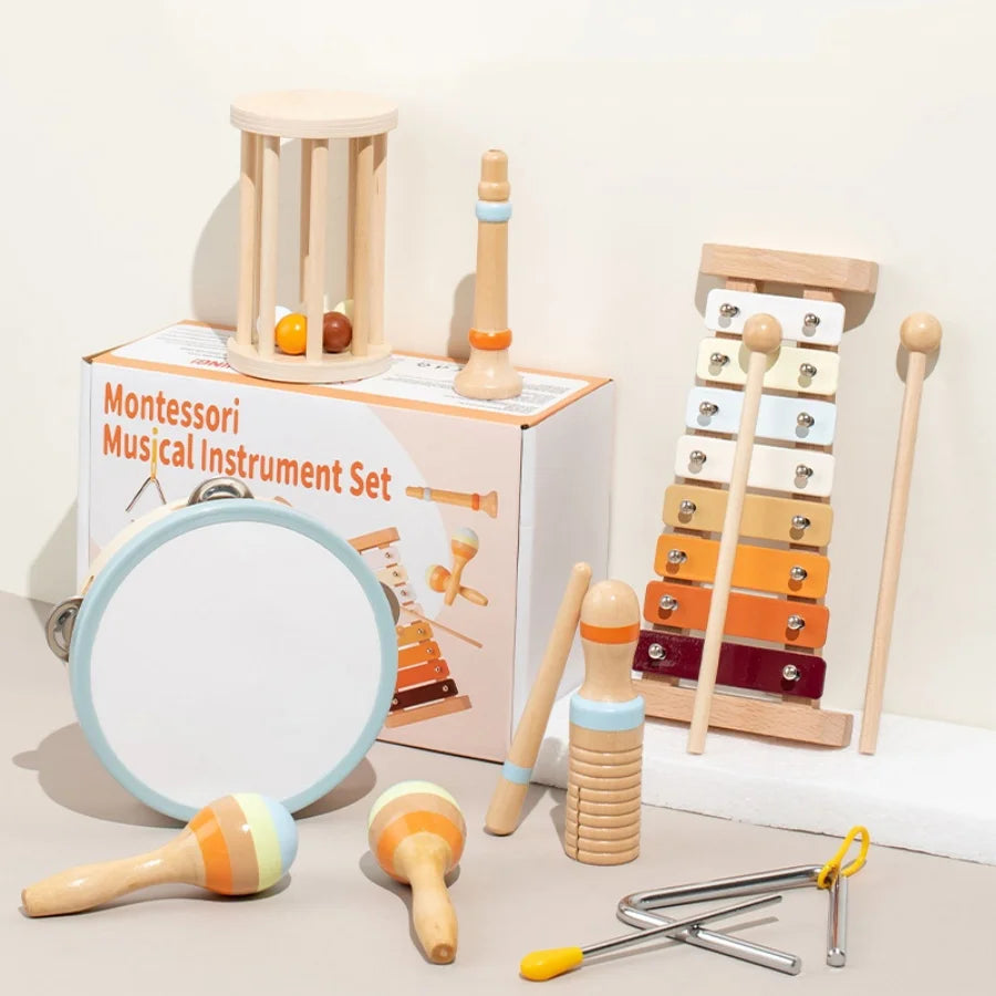 A set of wooden musical instruments including a rattle, drum, and various wooden toys for babies.
