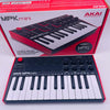 A red box and a white MIDI keyboard controller featuring drum pads and knobs for the AKAI MPK Mini.