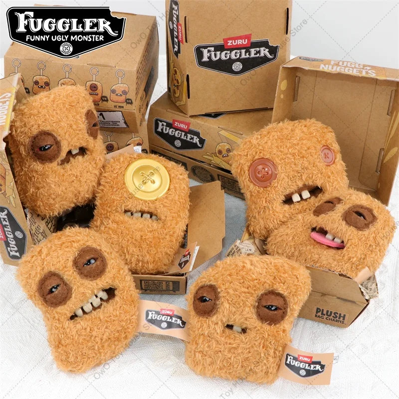 A collection of Fuggler plush toys in various shades of brown and orange, packaged in cardboard boxes.
