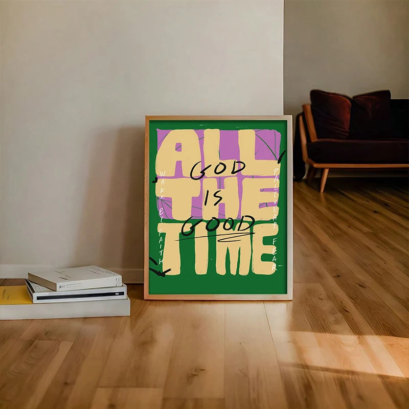 A framed canvas print with the text ALL GOD IS GOOD THE TIME in yellow and purple on a green background