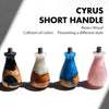 A collection of five short handle espresso portafilters made of resin and wood in various colors.