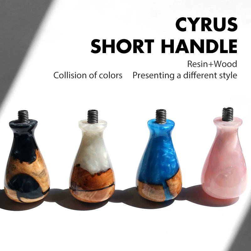A collection of five short handle espresso portafilters made of resin and wood in various colors.
