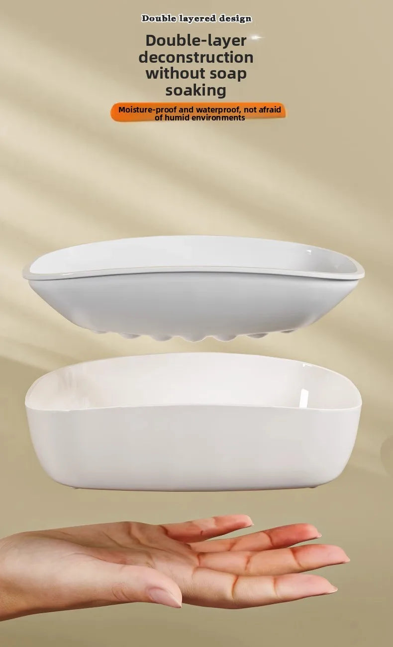 A white double-layer draining soap dish is shown floating above a hand, highlighting its moisture-proof design.