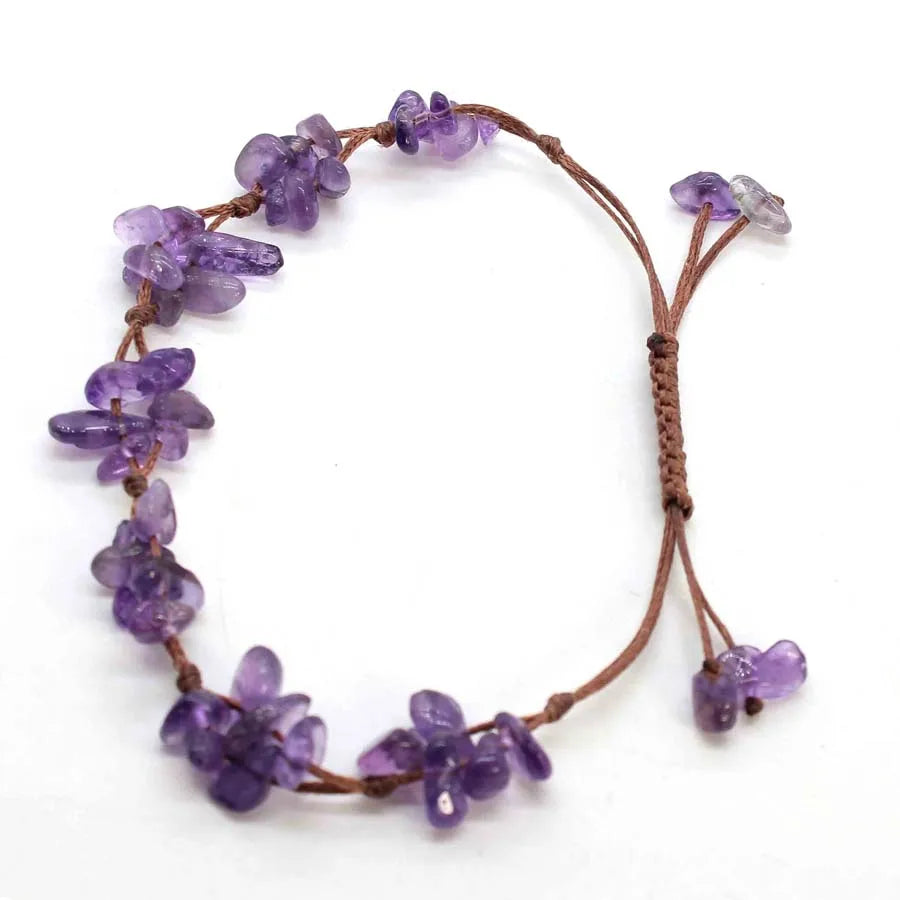 A bracelet made of purple crystal chips braided together on a natural cord.