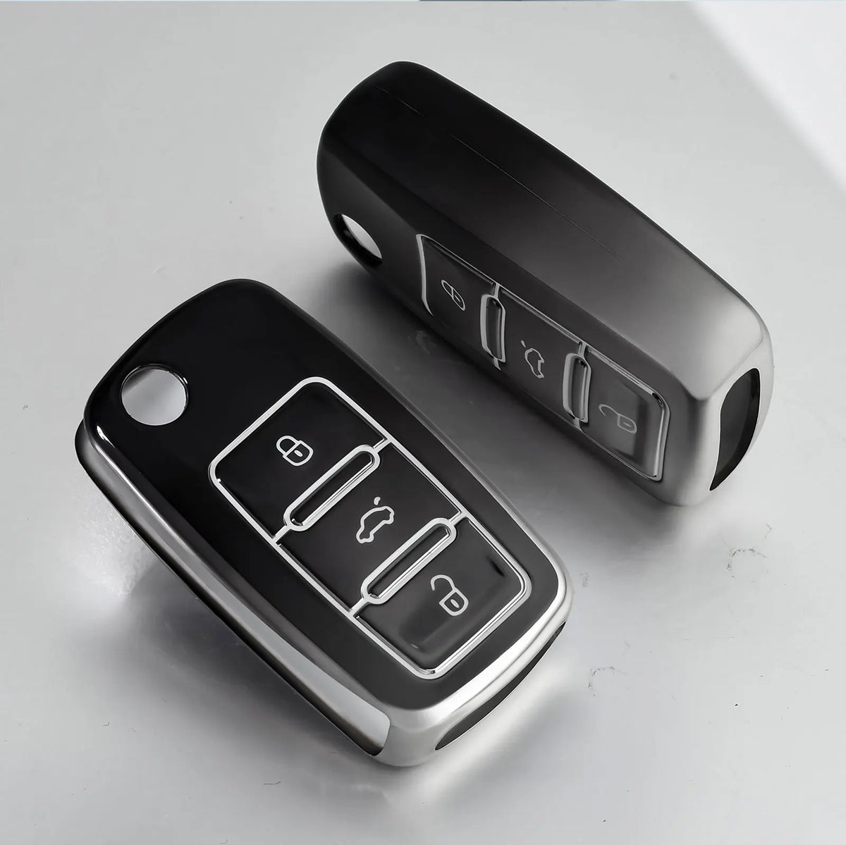 A black soft TPU car key cover for VW, Skoda, and Seat vehicles shown on a white surface.