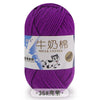 Purple milk cotton blend yarn skein with a label showing the name and thickness.