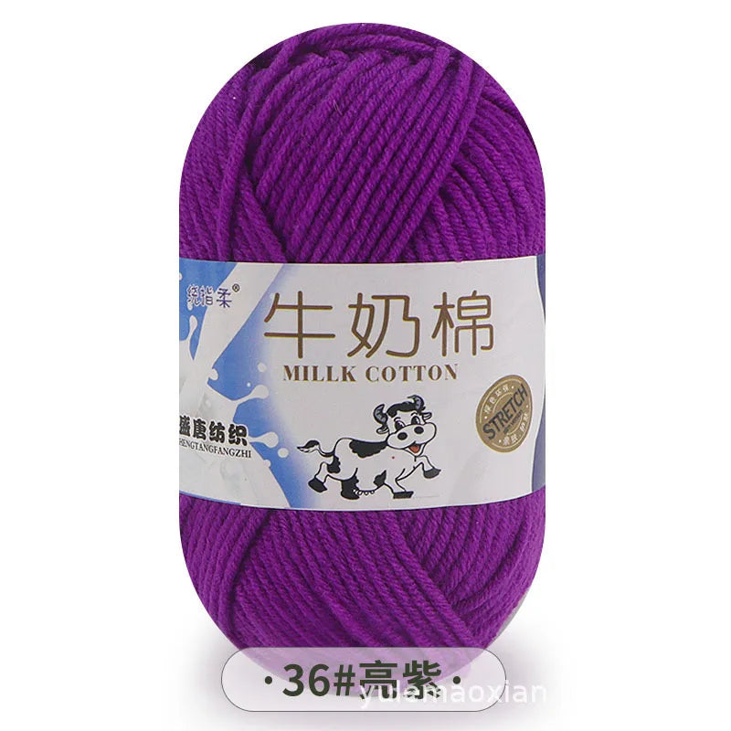 Purple milk cotton blend yarn skein with a label showing the name and thickness.