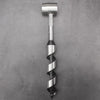 A silver manual wood auger drill with a spiral design and a leather holster.