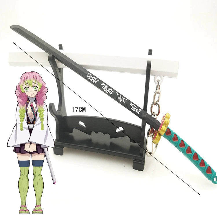 A miniature replica of a Demon Slayer katana sword with a green hilt and a pink-haired anime character standing next to it.