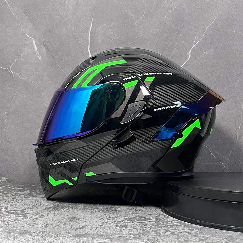 A black modular flip-up motorcycle helmet with bright green accents and a blue visor displayed on a gray background.