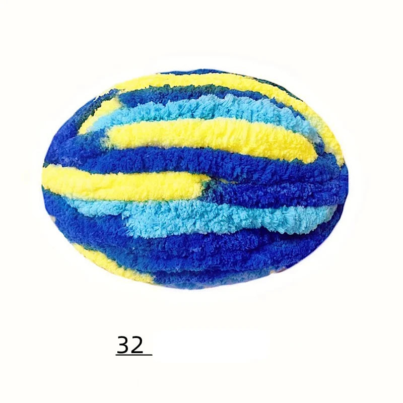 A spherical ball of bright blue and yellow chenille yarn with horizontal stripes.