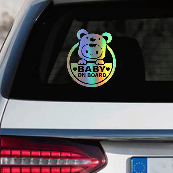A reflective decal featuring a cute bear design with the text Baby On Board on a car window.