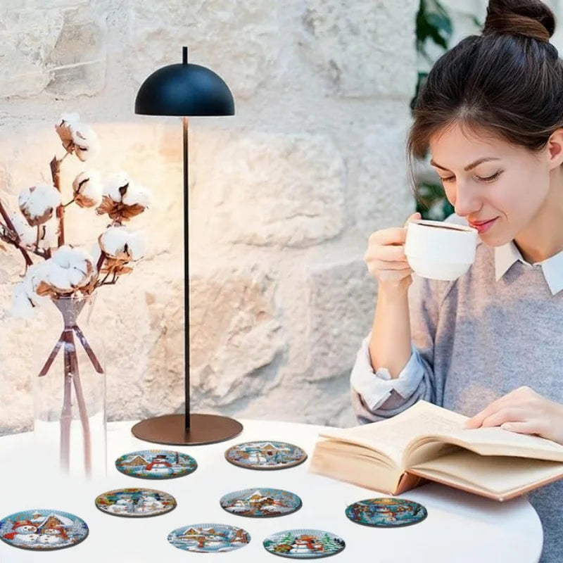 A woman is looking at a cup of coffee while a DIY diamond art coaster set with wooden bases and eight designs is displayed on