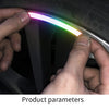 A hand is applying a colorful LED sticker to the rim of a tire wheel for night safety and style.
