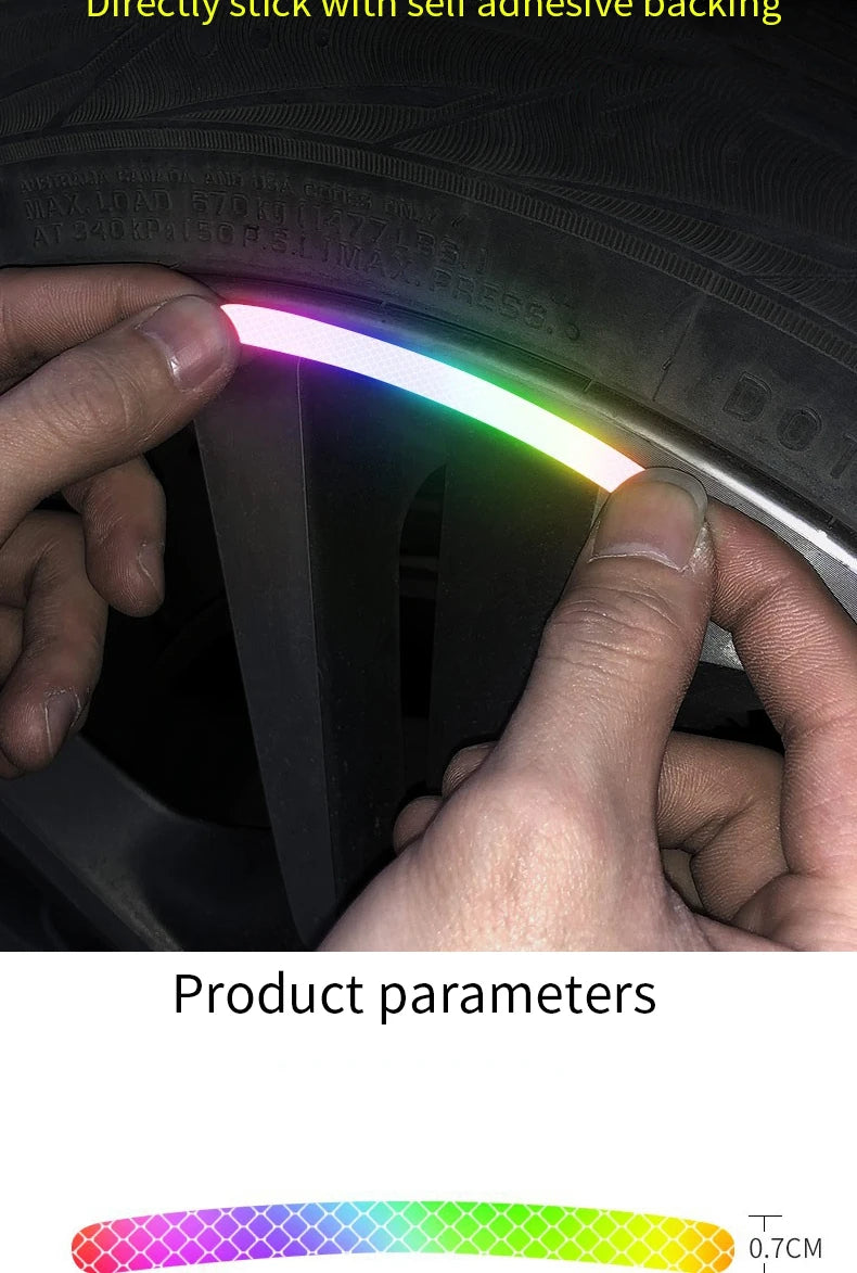 A hand is applying a colorful LED sticker to the rim of a tire wheel for night safety and style.