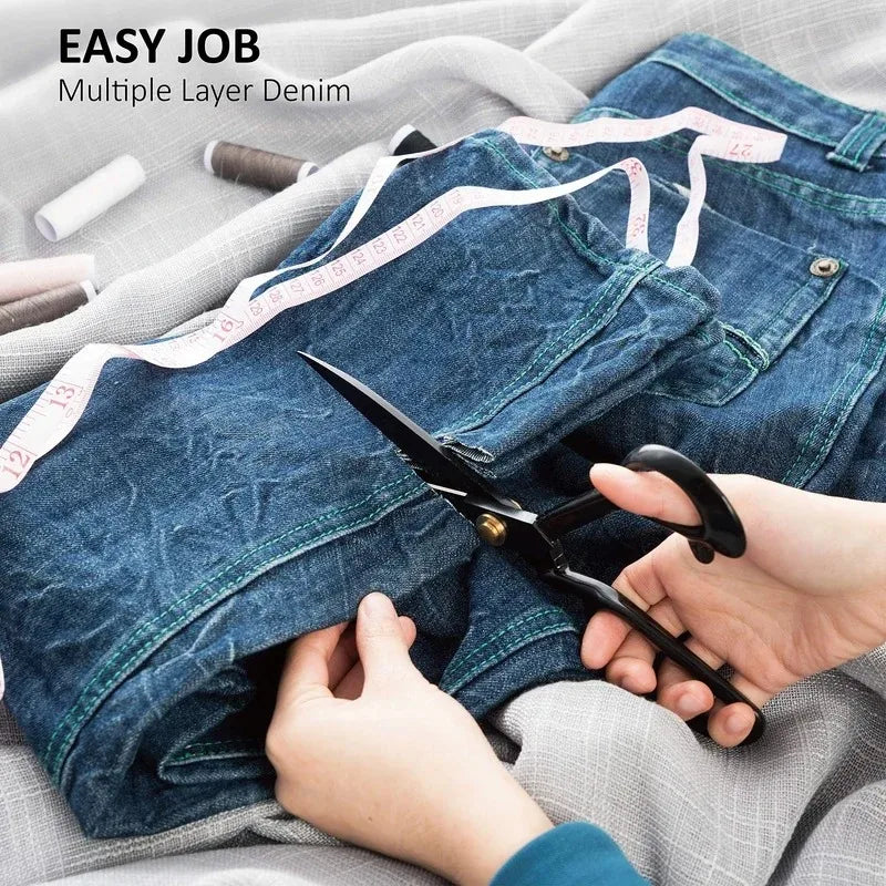 Hands using professional heavy-duty fabric shears to cut multiple layers of denim fabric