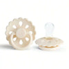 A white silicone baby pacifier with a flower-like design and a clear silicone nipple.
