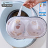 A mesh laundry bag for delicates is shown inside a washing machine drum.