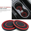 A set of two black and red non-slip silicone car cup holder coasters shown in use and separately.