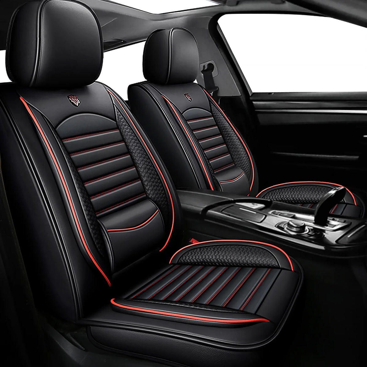 Black leather car seat covers with red stitching and accents shown in a vehicle interior.