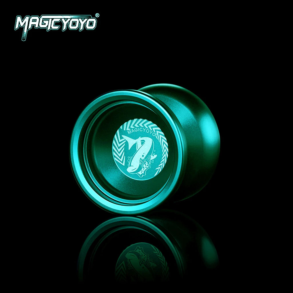 A close-up view of a shiny teal metal yoyo with a circular logo featuring a shark design.