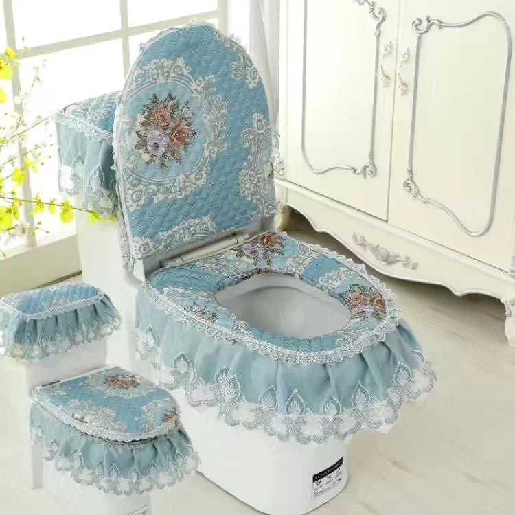A set of light blue and white antibacterial toilet seat covers with floral lace trim displayed on a white toilet.