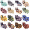 A collection of various natural tumbled crystal stone chips in multiple colors and textures.