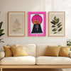 A display featuring a vintage rotating candy frame in pink and white frames on a light wall.
