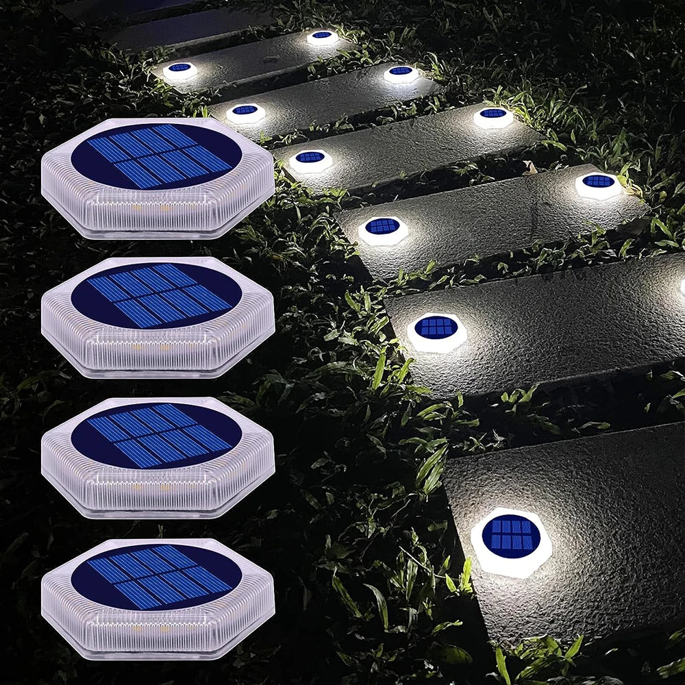 A series of solar powered LED step and path lights illuminating a garden pathway.