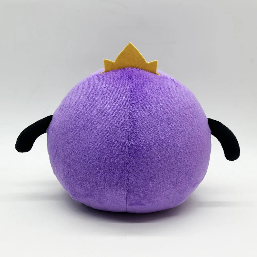 A cute purple plush doll with a golden crown on top.