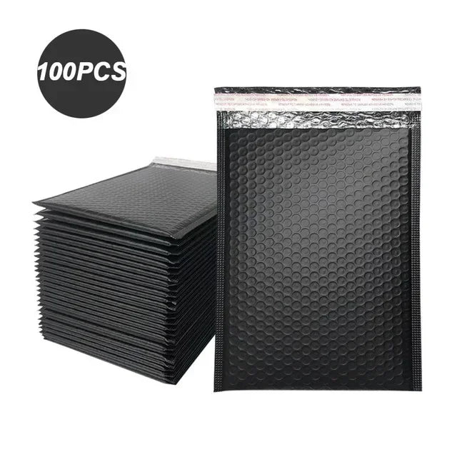 A stack of 100 black bubble mailers in clear packaging.