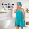 A plus size woman models a teal wrap robe and turban set in a bright bathroom setting.