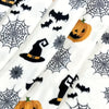 White flannel throw blanket featuring a spooky Halloween print with bats, witches, and pumpkins.