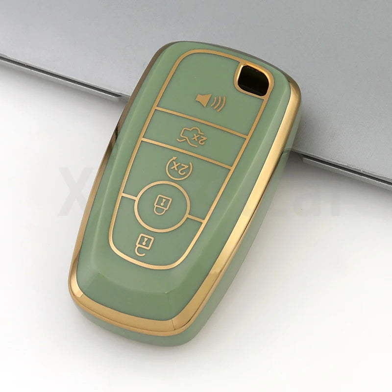 A light green TPU car key fob cover case with multiple buttons and a gold trim, shown in a close-up view.