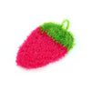 A bright pink strawberry scrubber sponge with green accents.