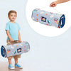 A toddler is holding an all-in-one nap mat with a removable pillow and fleece blanket featuring colorful designs.